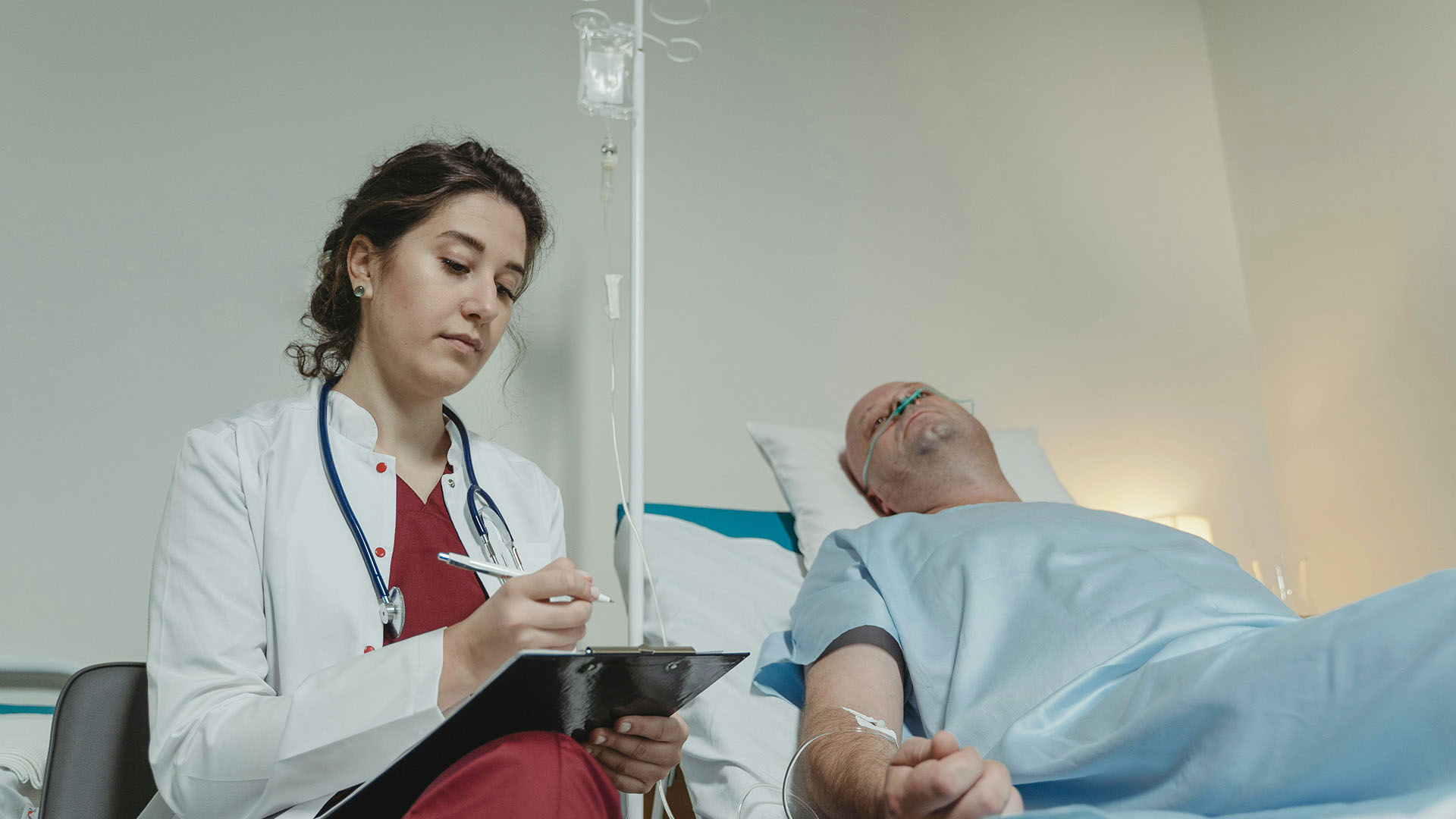 doctor sitting beside a patient