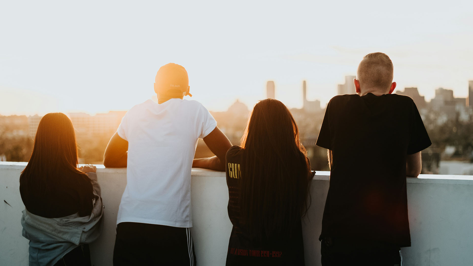 four person looking at the city