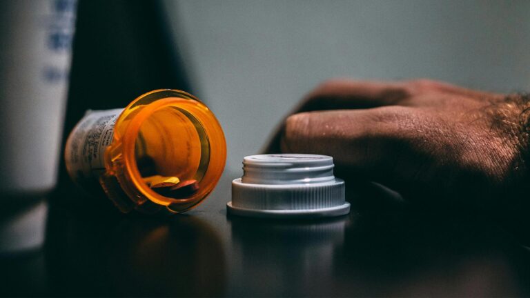 orange and white prescription bottle on table