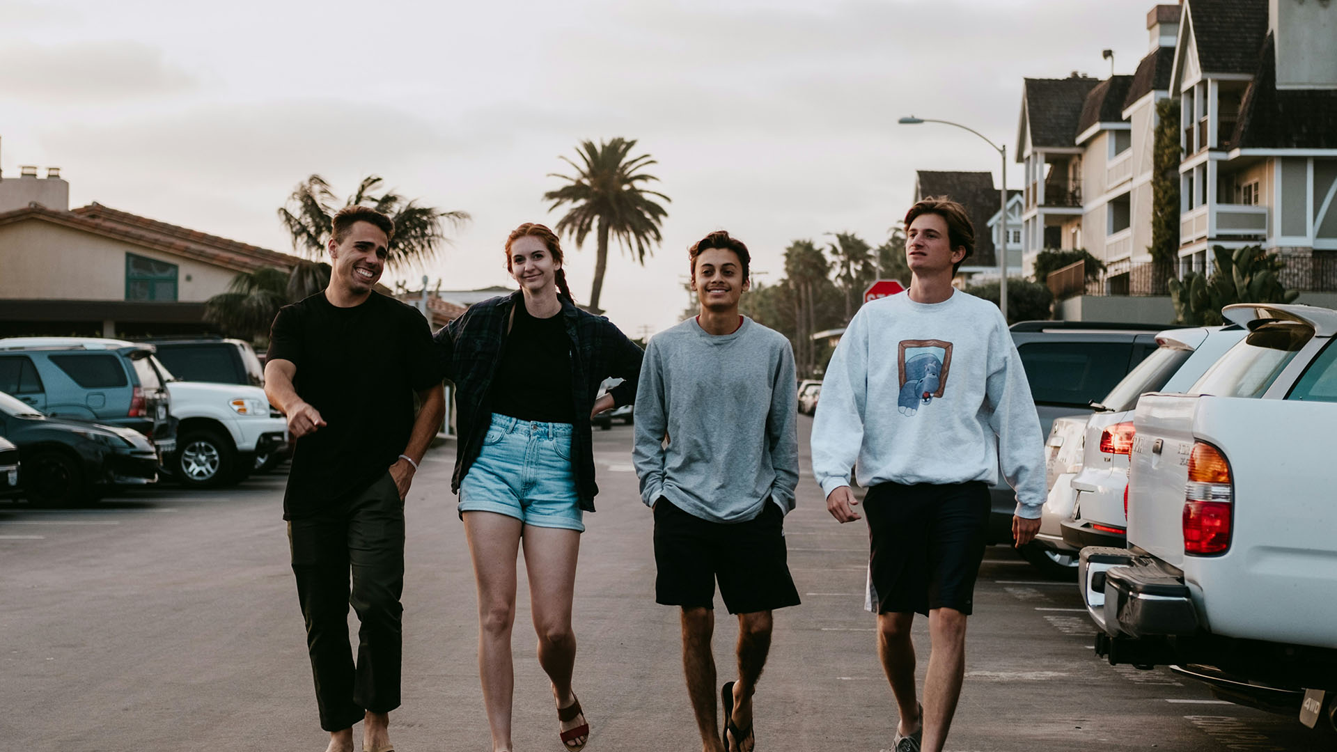 four person walking near vehicle