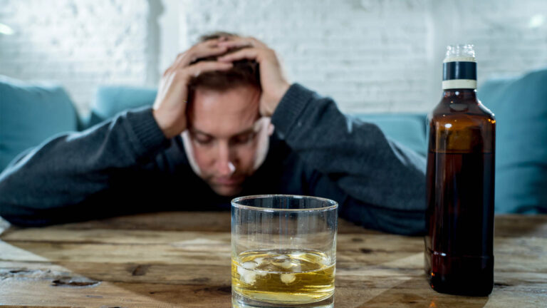man drinking whiskey glass bottle depressed