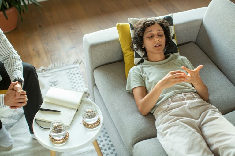 Woman relaxing on couch during addiction recovery therapy session at Scottsdale Detox