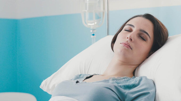 Young female patient lying in bed at the hospital