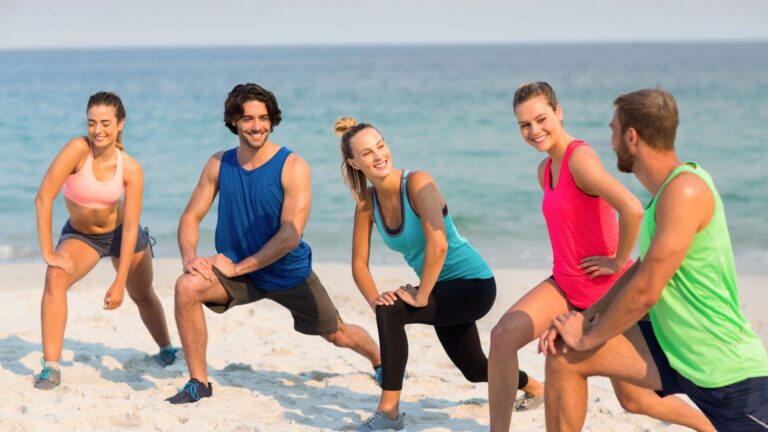 friends stretching on shore