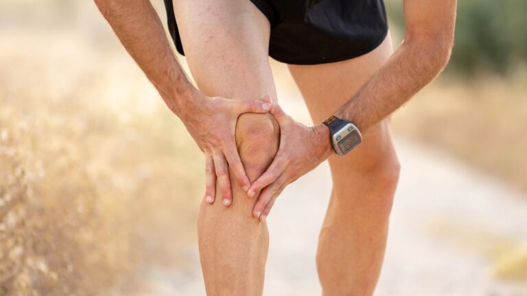 holding knee suffering pain
