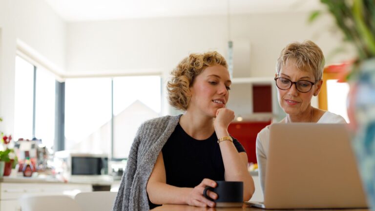 Mother and daughter discussing anxiety treatment options on a laptop.