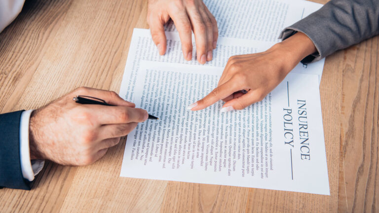pointing with finger at insurance policy contract