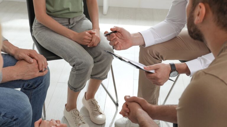group of drug addicted people at therapy session