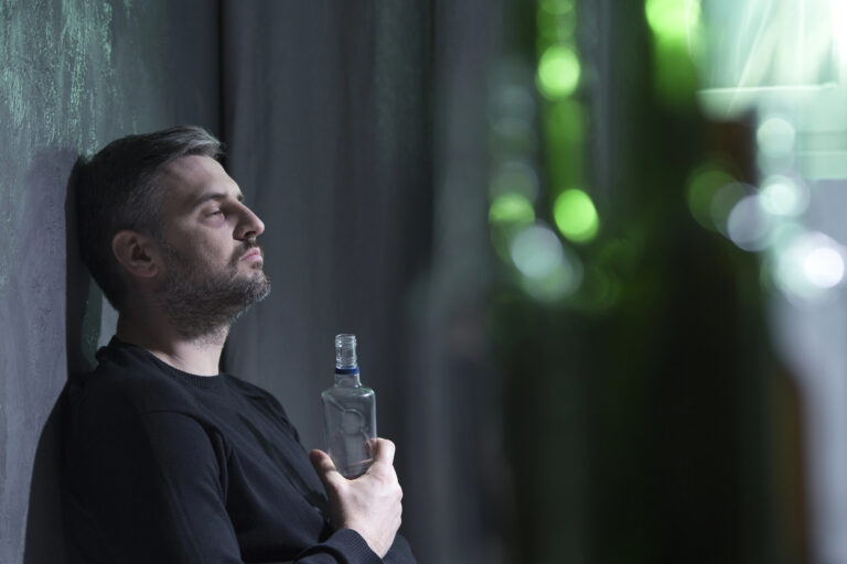 lonely man holding bottle