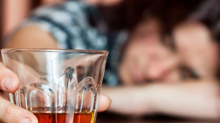 intoxicated woman holding an alcoholic drink