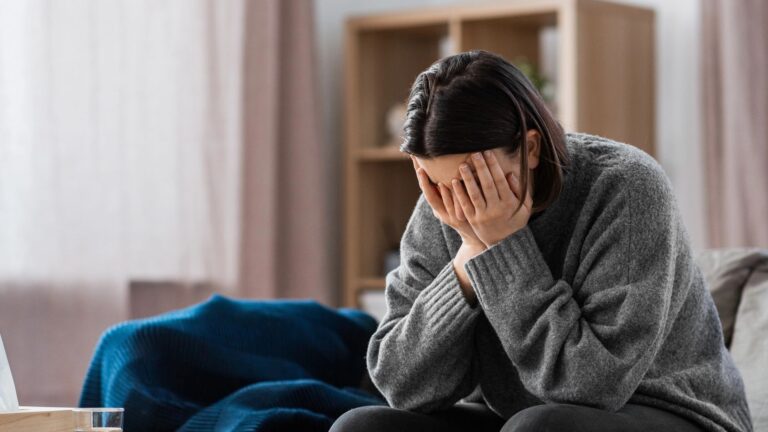 stressed woman having headache at home