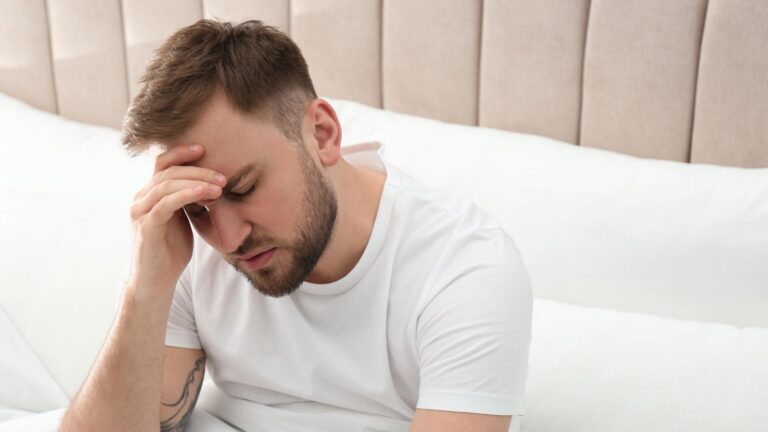 dizzy young man in bed