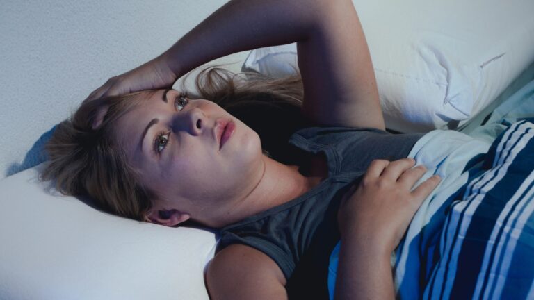 young woman lying on the bed