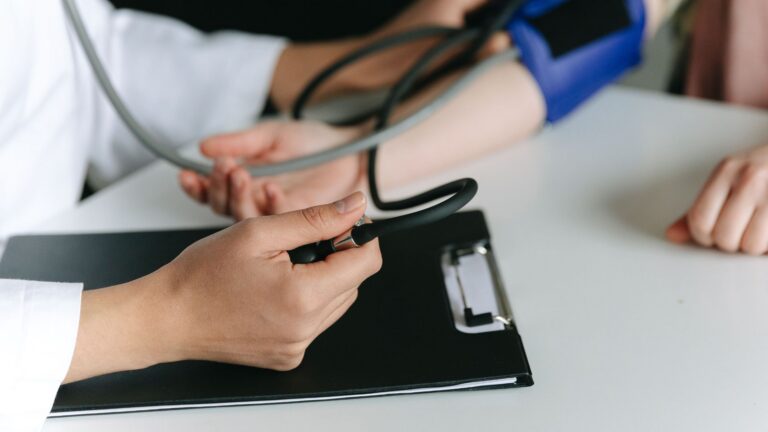 medical professional measuring a patient's blood pressure