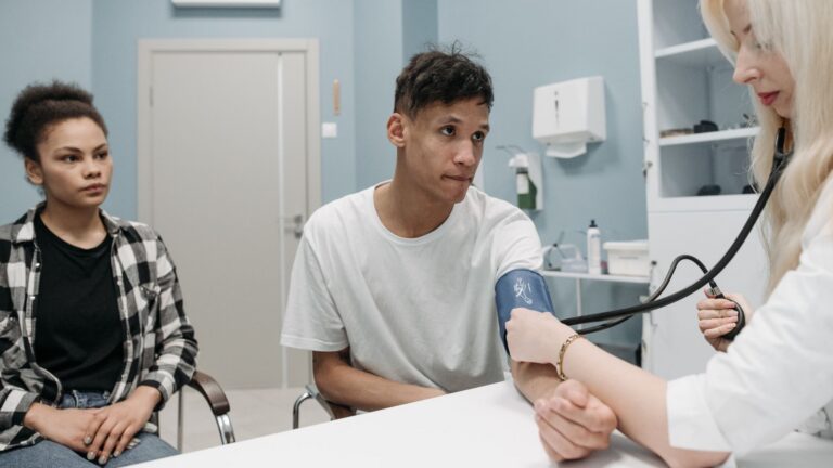 A doctor checks a patient's blood pressure