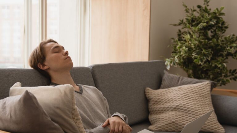 Person relaxing on a sofa indoors