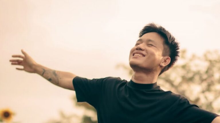 A happy man with arms outstretched