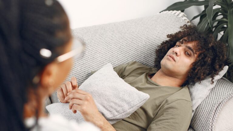Man lying on couch during therapy session