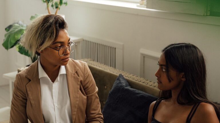Two women engaged in a counseling session indoors