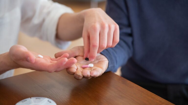hands passing medicine