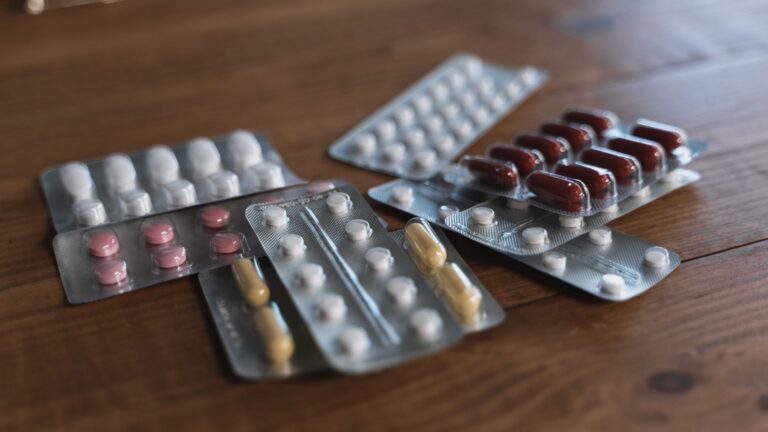 pills in blister packs displayed on a wooden surface
